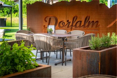 a table and chairs in front of a restaurant at Pension Restaurant Dorfalm in Leogang