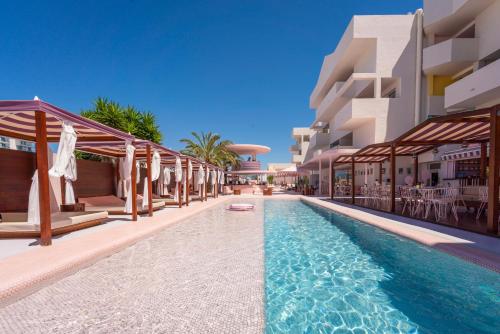 a swimming pool in front of a building at Paradiso Ibiza Art Hotel - Adults Only in San Antonio Bay