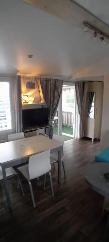 a living room with a table and a couch at Omaha beach mobilhome in Colleville-sur-Mer