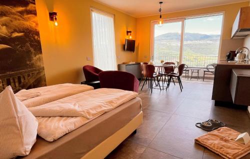 a room with two beds and a kitchen with a table at Maso Valèr - Agritur in Tassullo