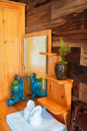 a room with a table with a potted plant on a shelf at Eco Farmer House - Sapa Retreat in Sa Pa