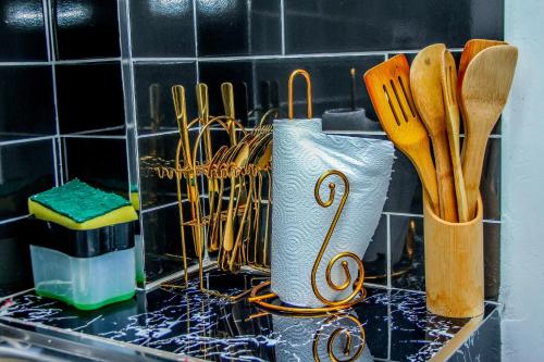 a kitchen counter with knives and utensils on it at Essence Urban Homes STUDIO in Kisumu