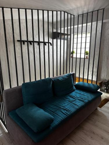 a couch with blue pillows in a room at Muz in Filiaşi
