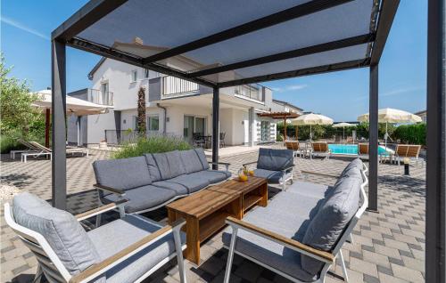 a patio with couches and a table and chairs at Gorgeous Home In Debeljak With Wifi in Debeljak