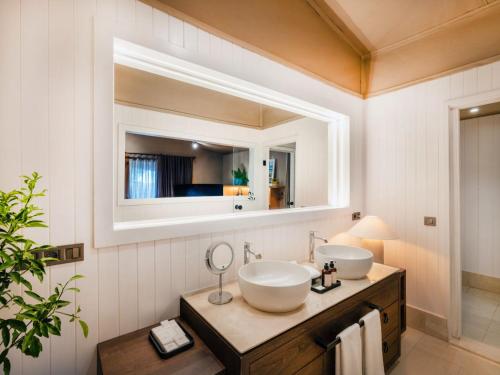 a bathroom with two sinks and a mirror at Yazz Collective in Fethiye