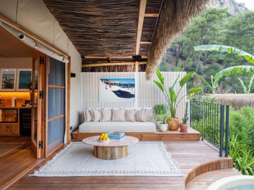 a porch with a couch and a table at Yazz Collective in Fethiye