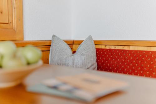 a table with a book and a bowl of apples at Kinderhotel Stegerhof in Donnersbachwald