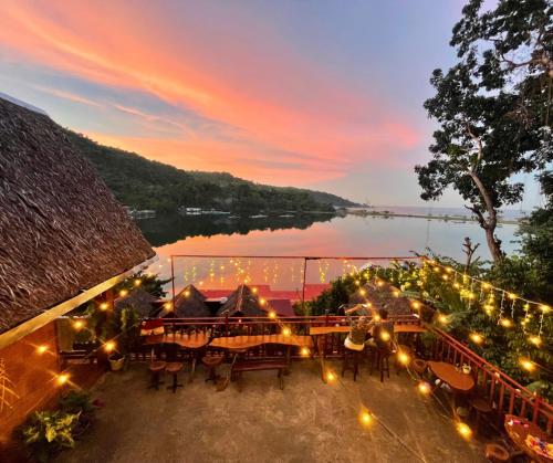 a view of a house with lights and a lake at Camiguin Blue Lagoon Cottages in Mahinog