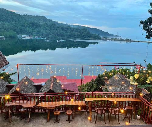 a view of a lake from a resort with lights at Camiguin Blue Lagoon Cottages in Mahinog