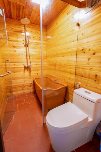 a wooden bathroom with a toilet and a tub at Eco Farmer House - Sapa Retreat in Sa Pa