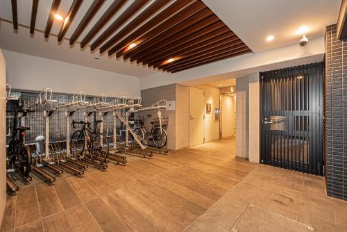 a gym with bikes lined up on the wall at Japan House 御徒町 in Tokyo