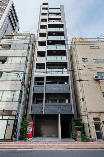 a tall apartment building with a lot of windows at Japan House 御徒町 in Tokyo