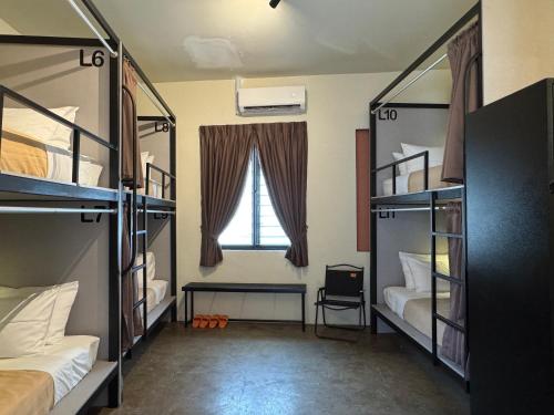 a room with two bunk beds and a window at Miner's House Ipoh in Ipoh