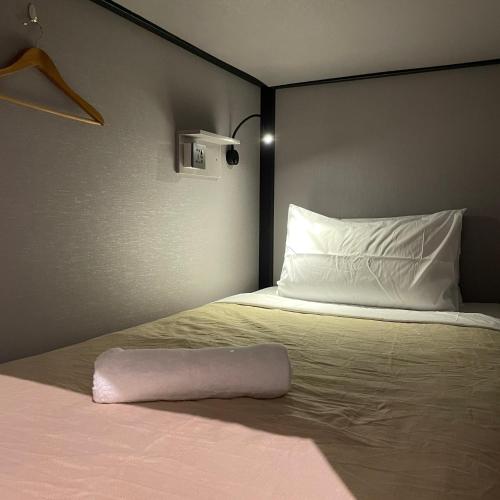 a bedroom with a bed with a pillow on it at Miner's House Ipoh in Ipoh