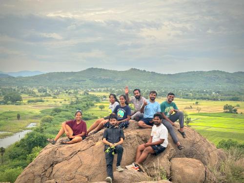 a group of people sitting on top of a rock at Ulala Hostels - Feels like HOME in Tiruvannāmalai