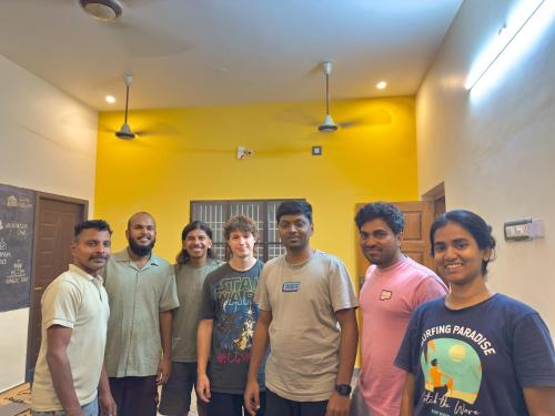 a group of men posing for a picture in a room at Ulala Hostels - Feels like HOME in Tiruvannāmalai