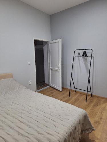 a bedroom with a bed and a mirror in a room at Studio Zmaj in Srbobran