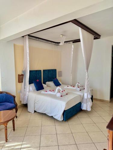 a bedroom with two beds with stuffed animals on them at Nyali Beach Holiday Resort in Nyali
