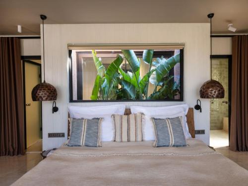 a bedroom with a bed with a large picture above it at Yazz Collective in Fethiye