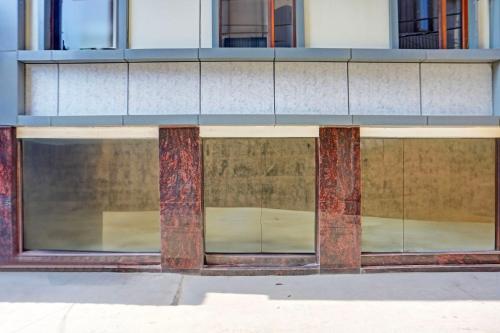 a building with glass windows and brick pillars at FabHotel CG International in New Delhi