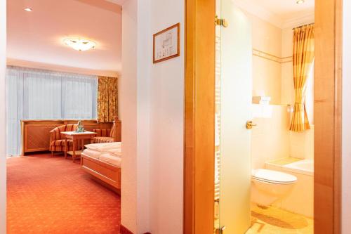 una habitación de hotel con una cama y un baño en Unser Berghof, en Erpfendorf