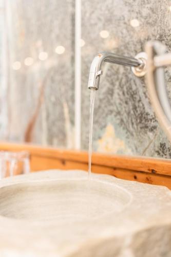 a stream of water coming out of a sink at Hotel Glemmtalerhof in Saalbach Hinterglemm