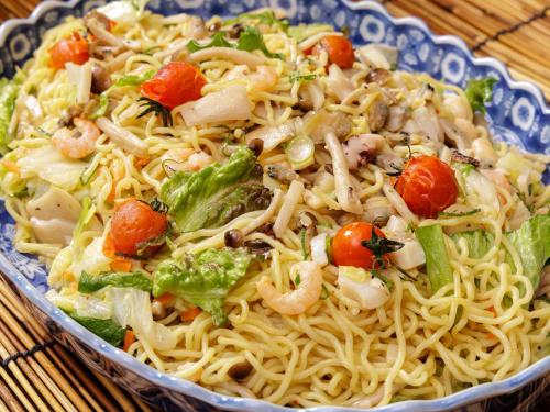 a pasta dish with shrimp and vegetables in a bowl at Nishitetsu Inn Kochi Harimayabashi in Kochi