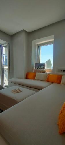 a room with two beds and a window at Clock House Skiathos in Skiathos