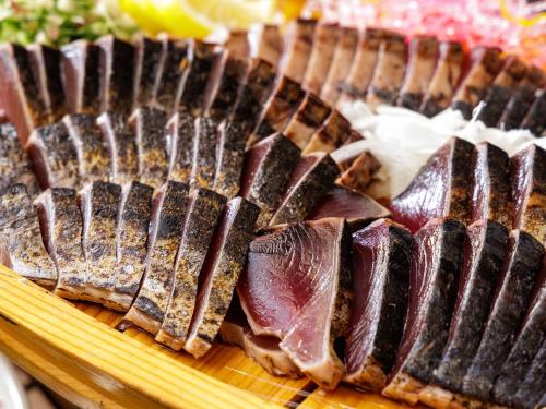 a plate of food with meat on a cutting board at Nishitetsu Inn Kochi Harimayabashi in Kochi