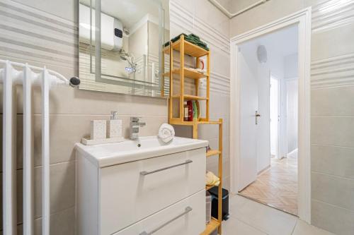 a bathroom with a sink and a mirror at Breathtaking Panorama view 3Br Balcony in Budapest