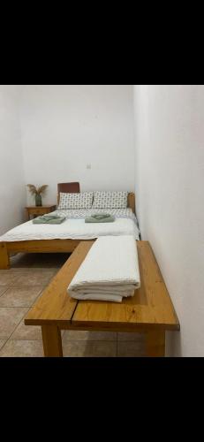 a bedroom with a bed and a wooden table at Mimi's House 1 in Chios