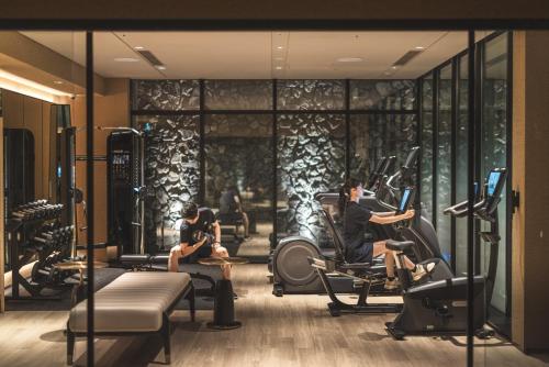 a gym with people sitting on exercise bikes at Dusit Thani Kyoto in Kyoto