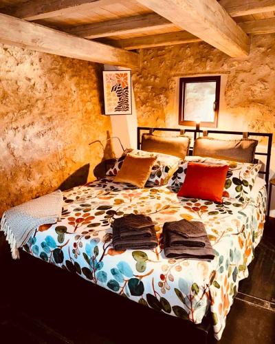 a bedroom with a bed with pillows on it at Il Rivellino - Tamerò Estates in Casperia