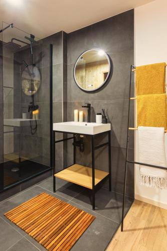 a bathroom with a sink and a mirror at Le chalet des bois in Lalaye