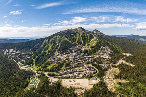 an aerial view of a town in the middle of a mountain at Winter Escape On Perfection - Ski In Out, Pool & Hot Tub in Big White