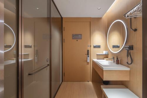 a bathroom with a shower and a sink at JI Hotel Beijing Zhongguancun Jiaotong University in Beijing