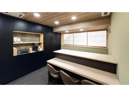 a waiting room with a counter and some chairs at FUMAI SAUNA&INN - Vacation STAY 66364v in Matsue