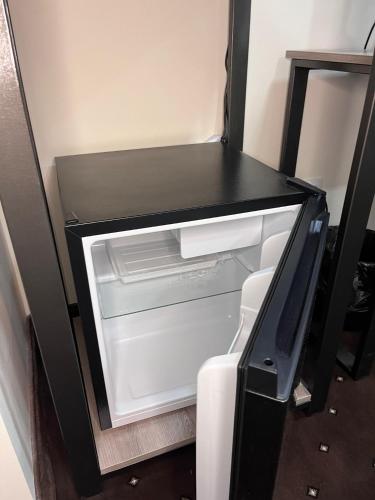 an empty refrigerator with its door open at Jermuk Verona Resort in Jermuk