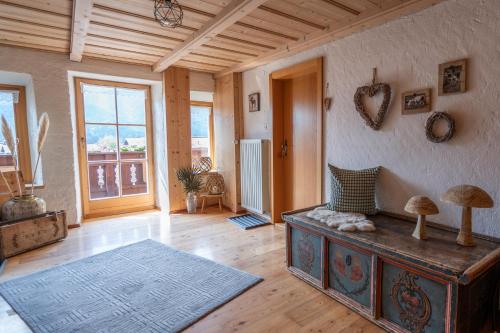 a living room with a table and some mushrooms on the wall at Beim Nuihausa in Reit im Winkl