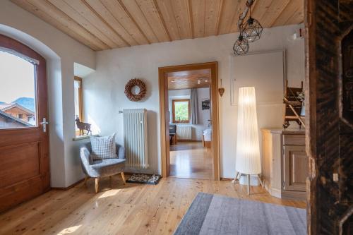 a living room with a chair and a window at Beim Nuihausa in Reit im Winkl