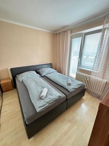a bedroom with a bed with two pillows on it at Apartmán Športovcov in Dolný Kubín