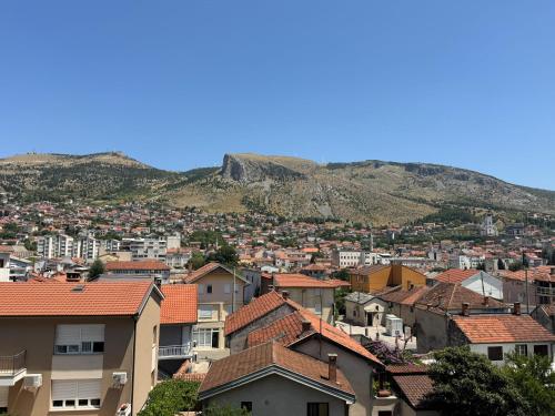 a city with houses and mountains in the background at Mostar Zen Apartment in Mostar
