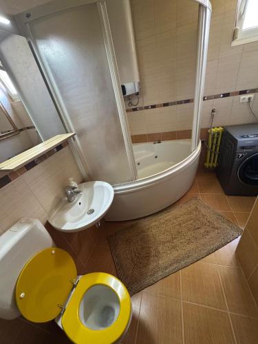 a bathroom with a toilet and a shower and a sink at Mostar Zen Apartment in Mostar