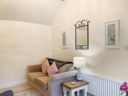a living room with a couch and a mirror at Swallows - Uk41742 in Mayfield