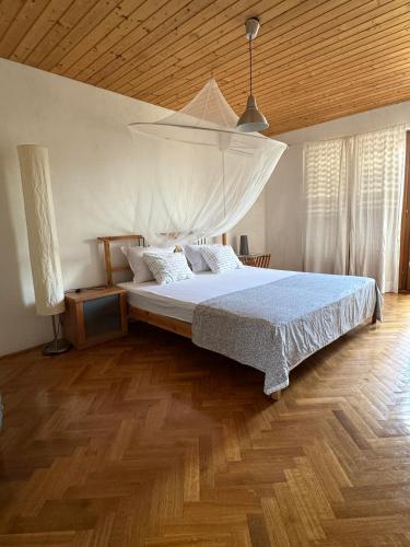 a bedroom with a large bed with a wooden ceiling at Villa Sunny Side in Ždrelac