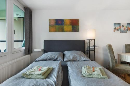 a bedroom with two beds with towels on them at Appartement Hella Wahnsinn in Sankt Englmar