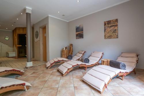 a room with a bunch of cushioned chairs in it at Beim Nuihausa in Reit im Winkl