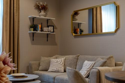 a living room with a couch and a mirror at LIFESTYLE Apartments in Bochnia