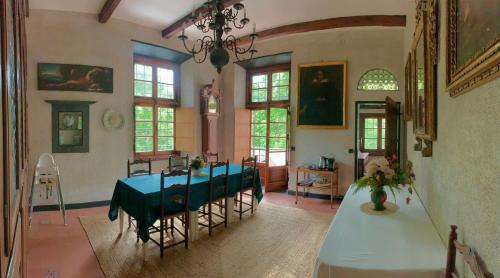 a dining room with a blue table and chairs at Relais Rantegosa - Holiday home in Chiavari
