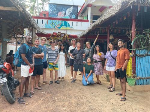 a group of people standing in front of a building at HostelExp, Varkala - A Beach Town Hostel in Varkala